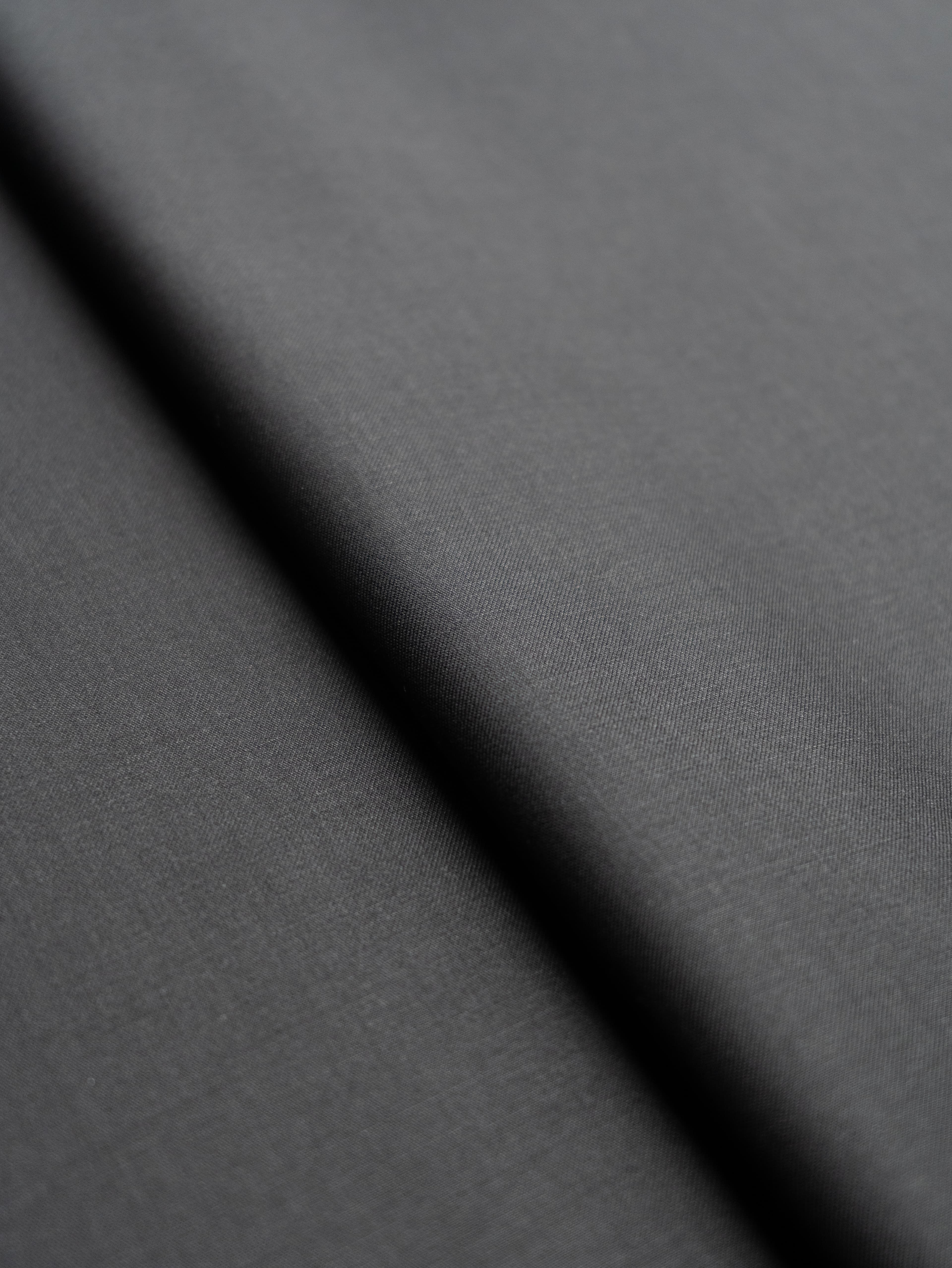 Close-up of silk-cotton blend fabric with subtle sheen, part of our workshop material selection